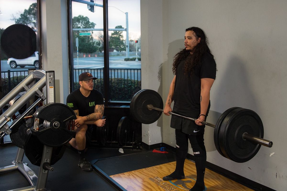 Andrew Delcarmen coaching a deadlift